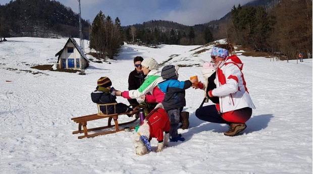 Tea break after sledding below St. Peter in Begunje